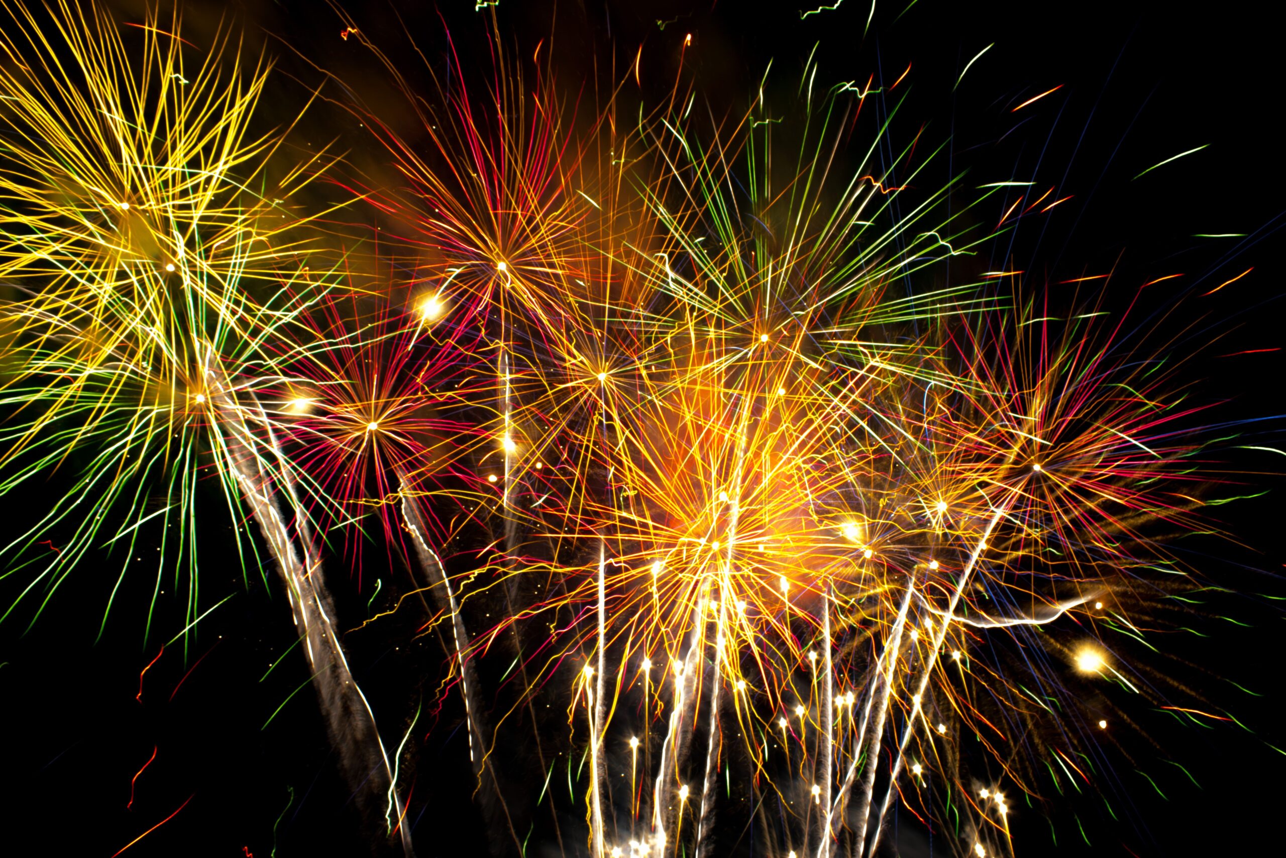 Vibrant fireworks lighting up the night sky with colorful sparks and bright explosions.